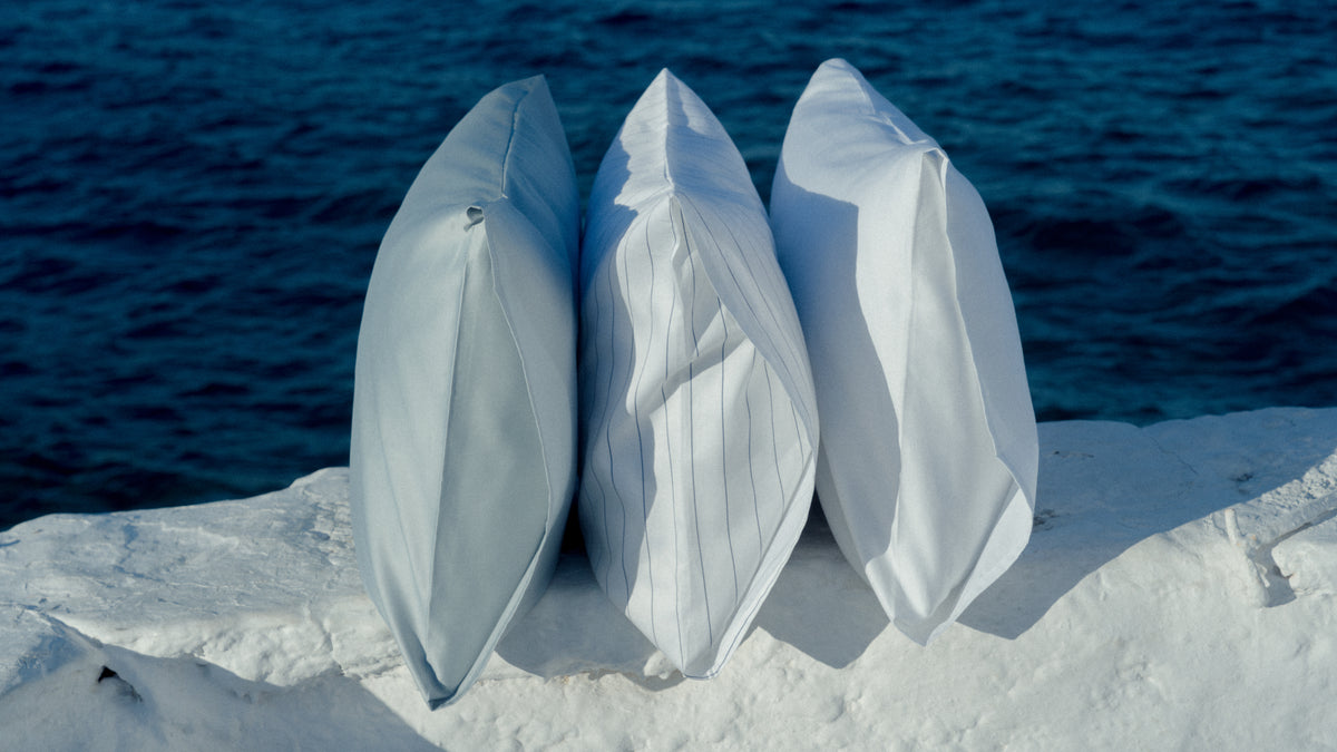 Pillows on a row with a blue ocean background