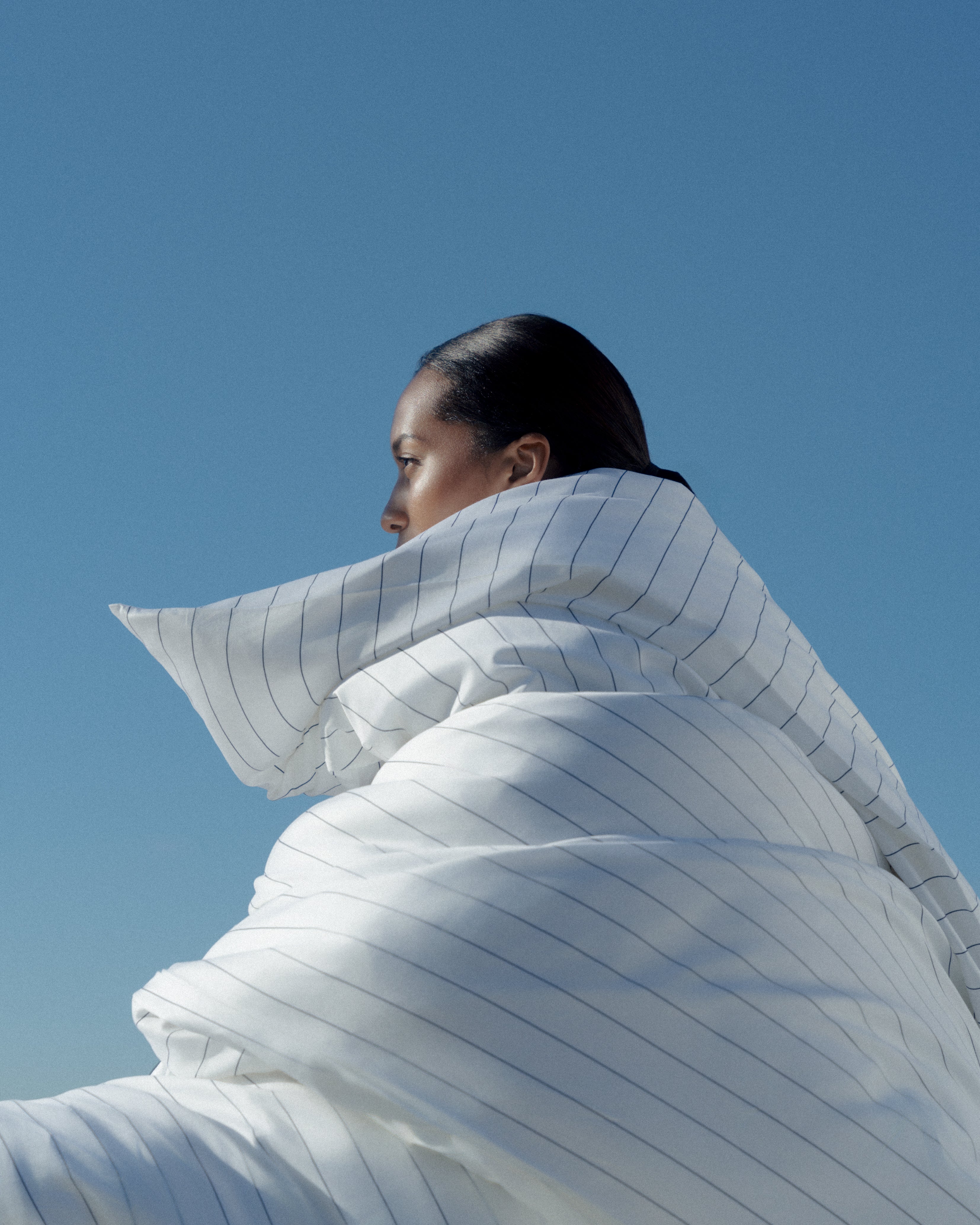 woman wrapped in a big soft duvet